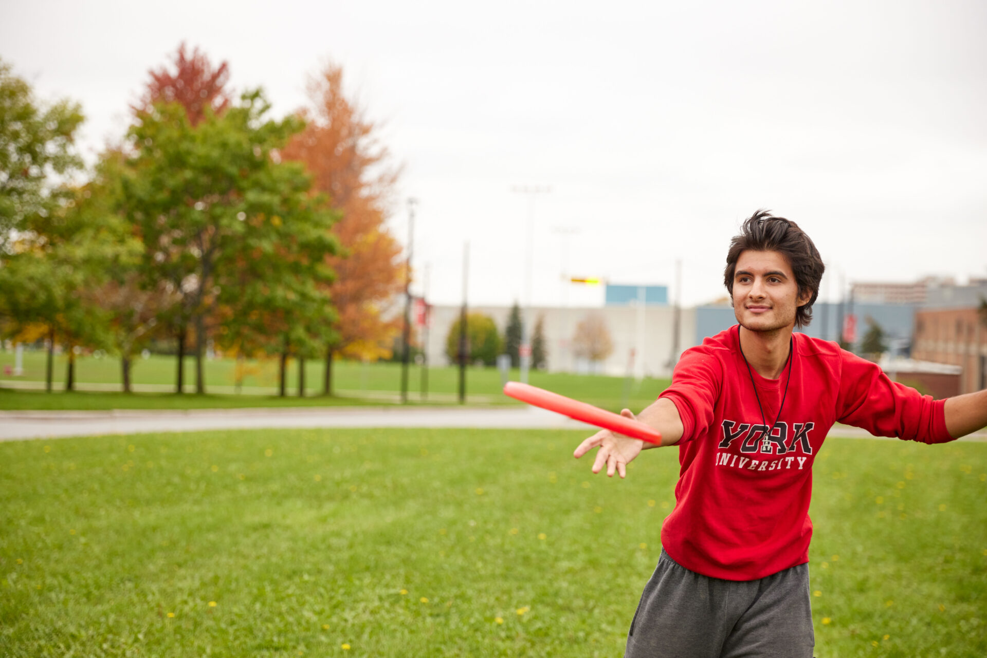 Man throwing frisbee on a field.