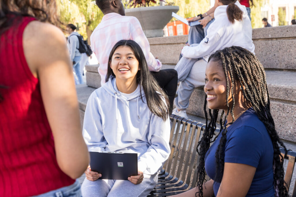 Two people sitting and smiling