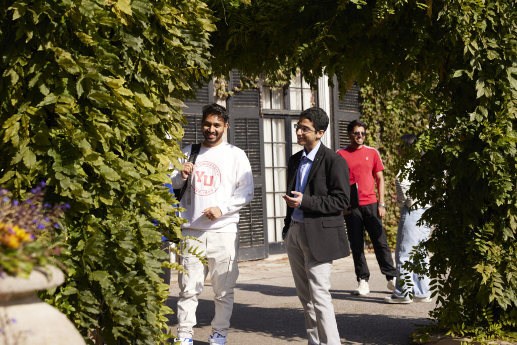 Two friends walking in a garden