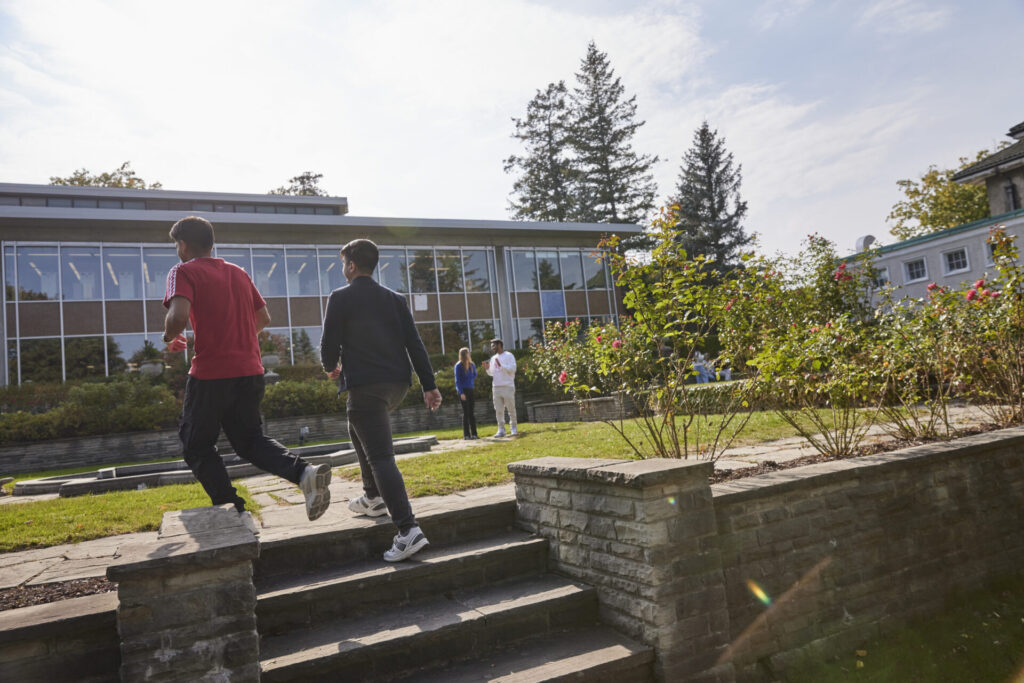 Students at Glendon Campus walking up stairs in a garden