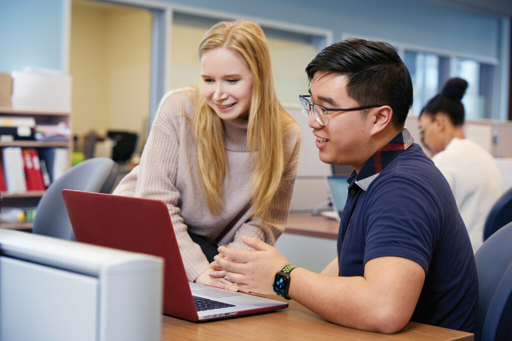 Woman and man looking at a laptop