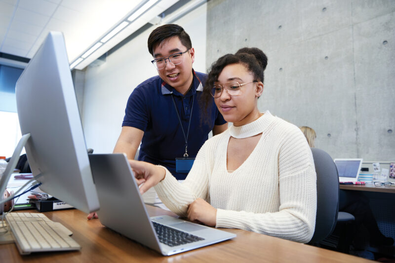 Woman and man looking at a laptop