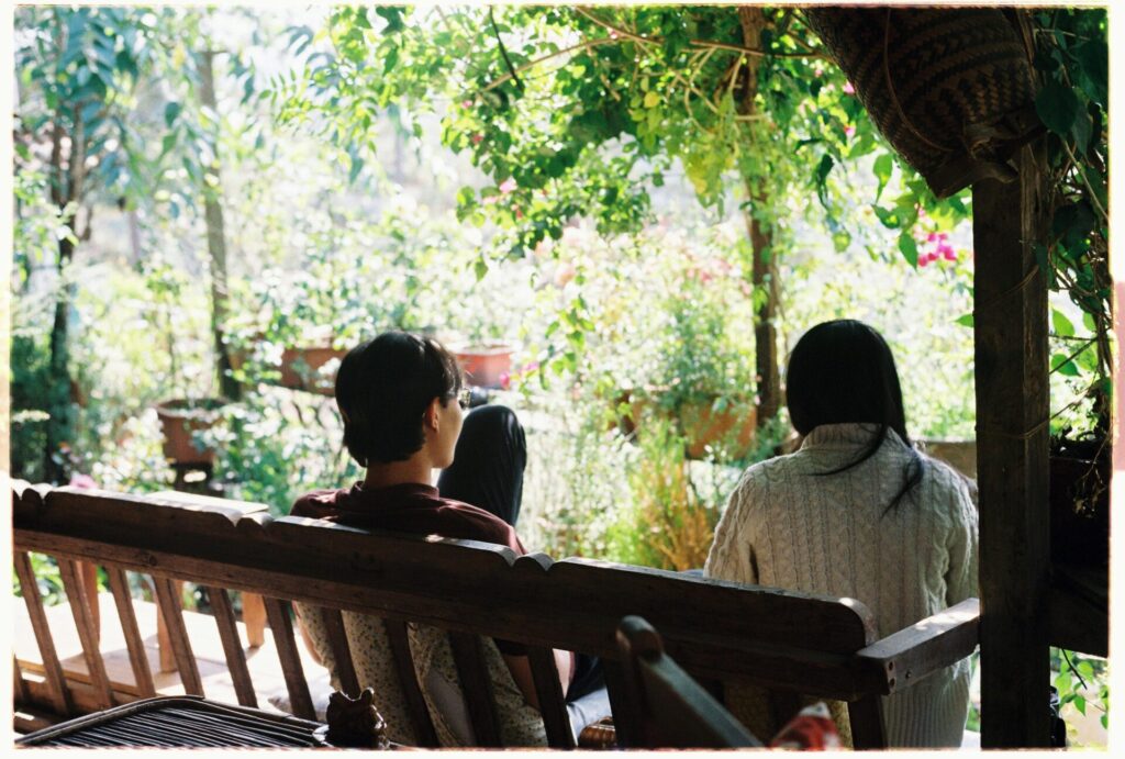 Couple sitting on a bench in a garden