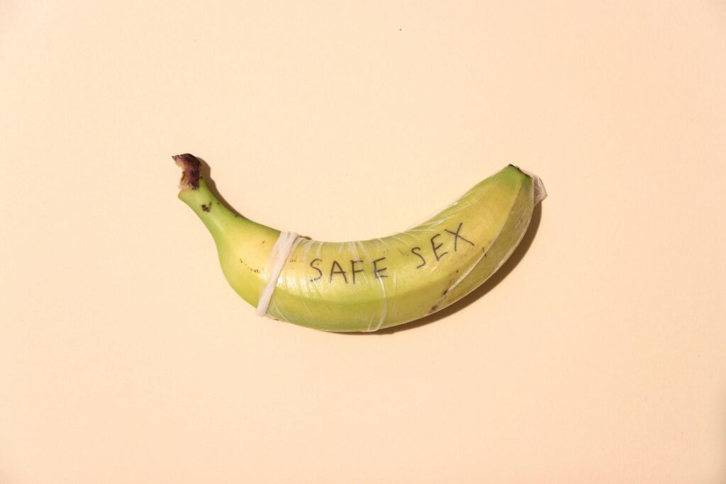 yellow banana on yellow surface saying safe sex