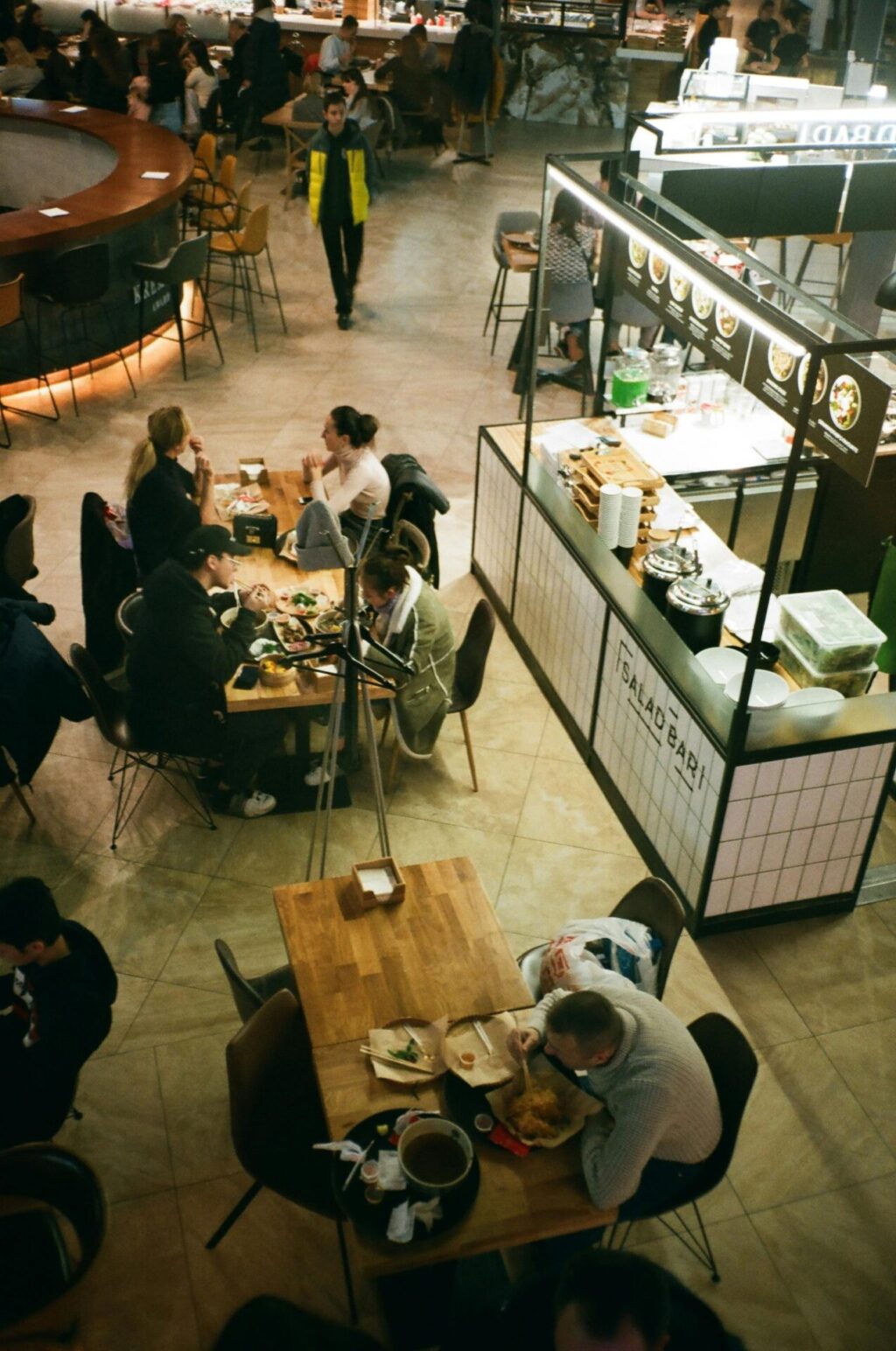 People eating in front of food stalls