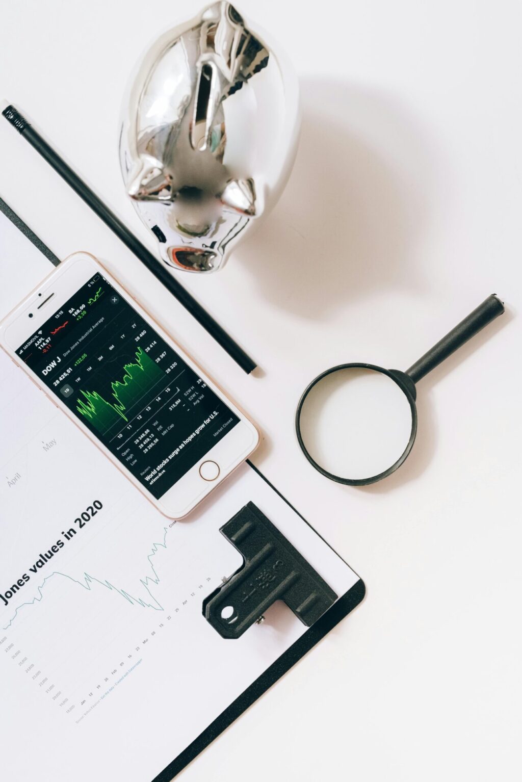 Smartphone and magnifying glass on the white table