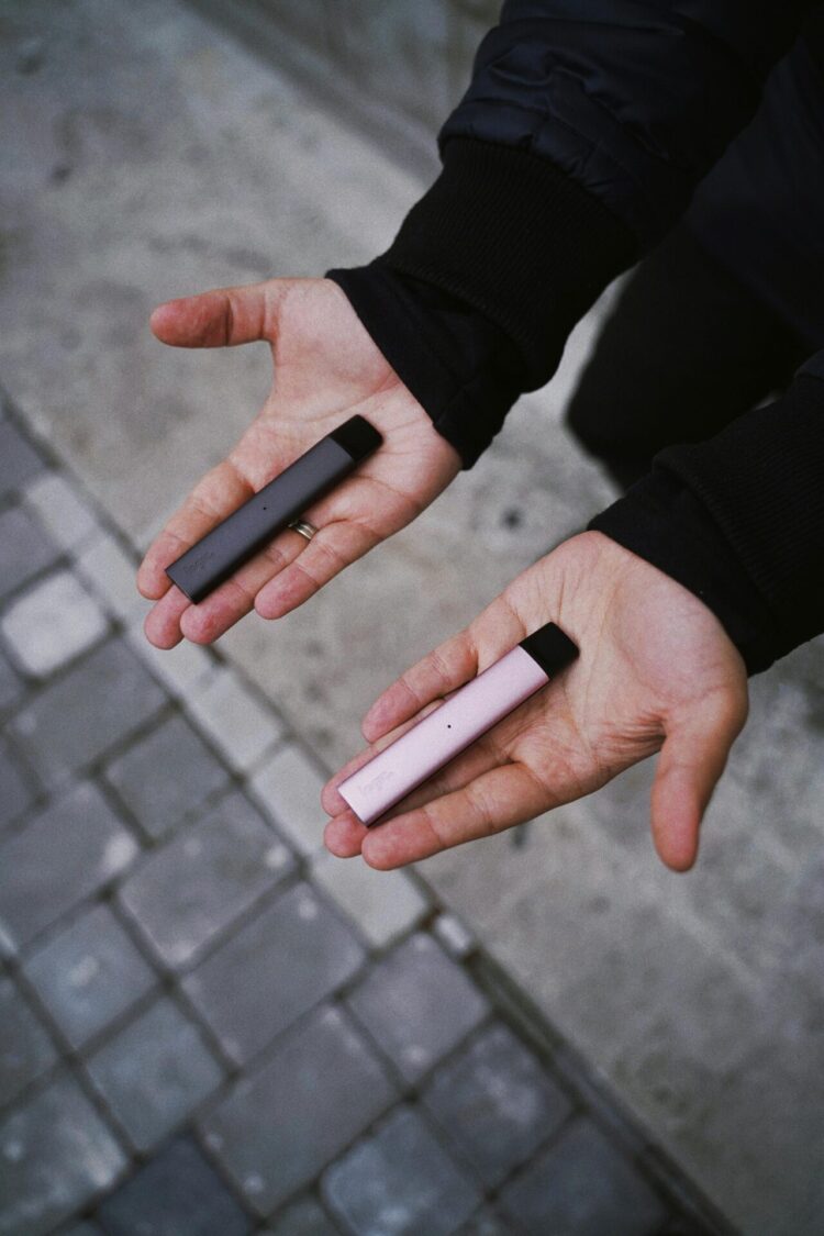 Person holds a vape in both hands