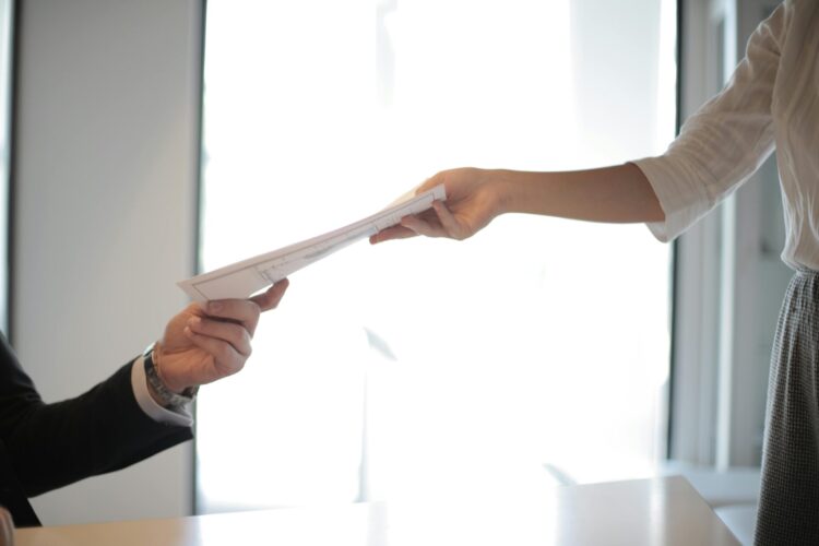 Job applicant passing her documents