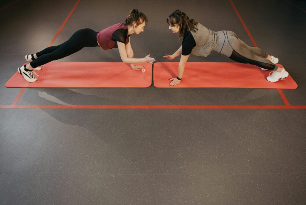 Women exercising together on red yoga mats