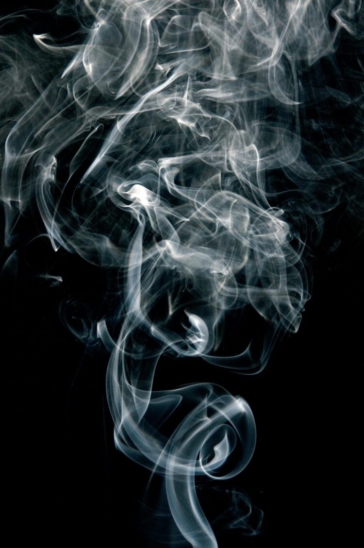 White smoke against black background