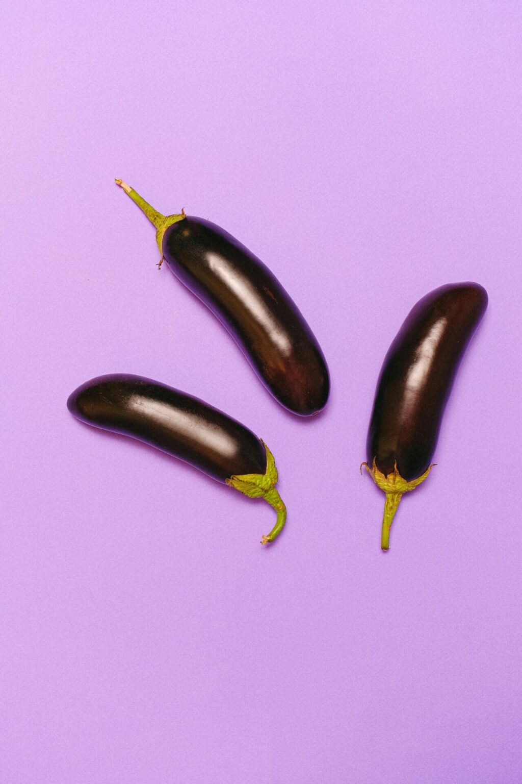 Eggplants on a light purple background