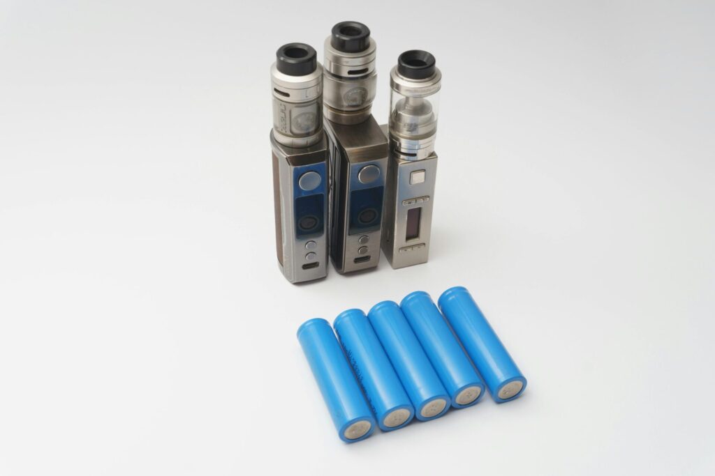 E-cigarettes and batteries on a white background