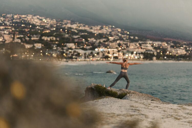 Women doing yoga near a beach