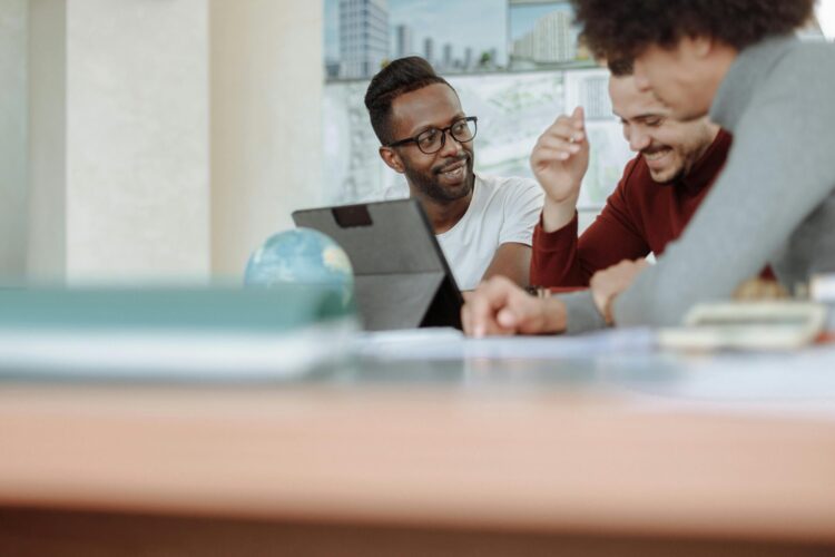 Men having a meeting in front of a computer