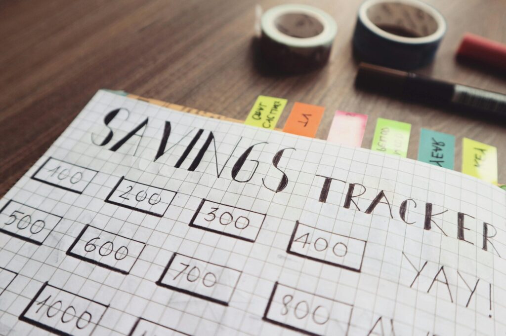 Savings tracker on brown wooden surface