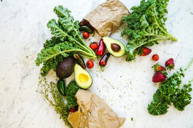 Photo of vegetables and fruits spread out with paper bags