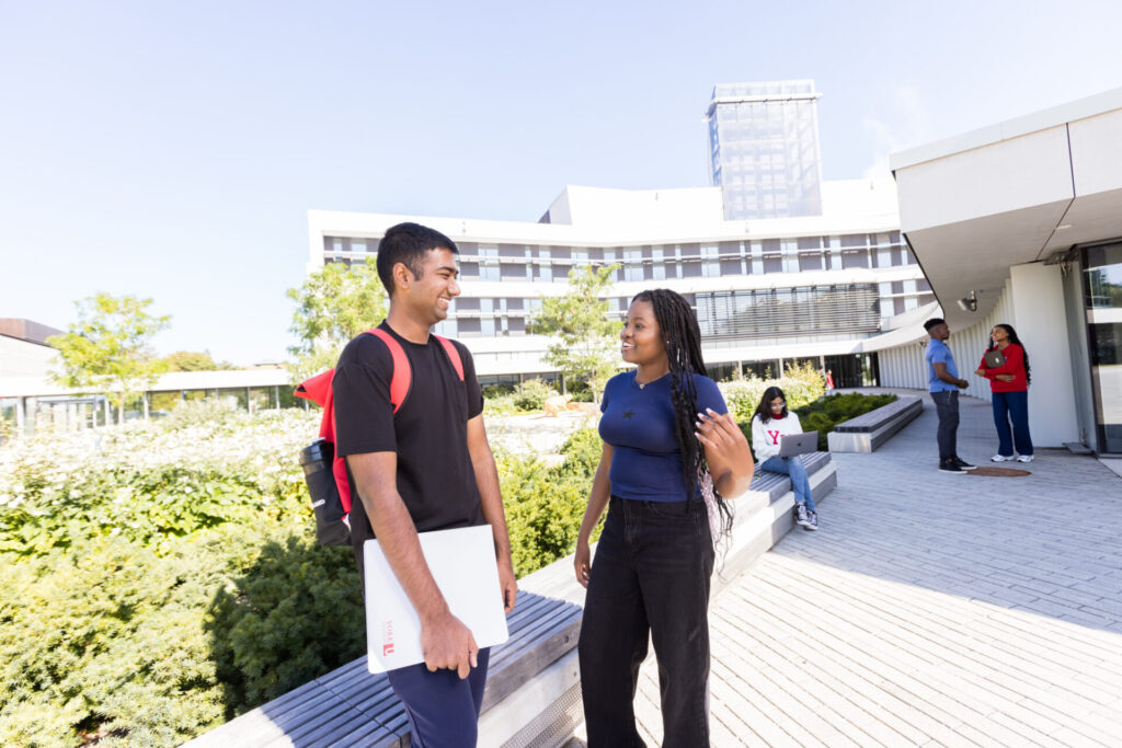 Two students standing and talking