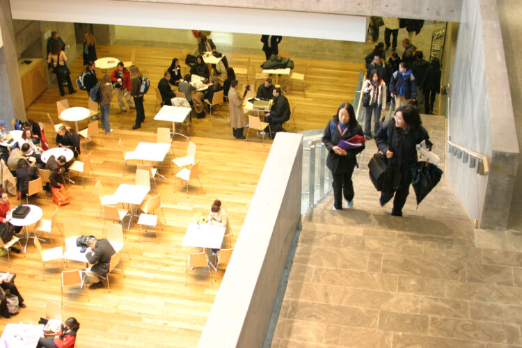 Students walking up the stairs in an atrium