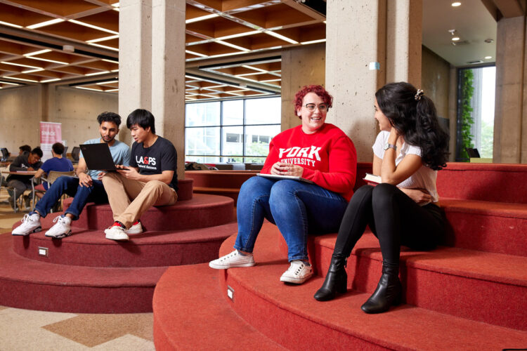 Students sitting in a foyer