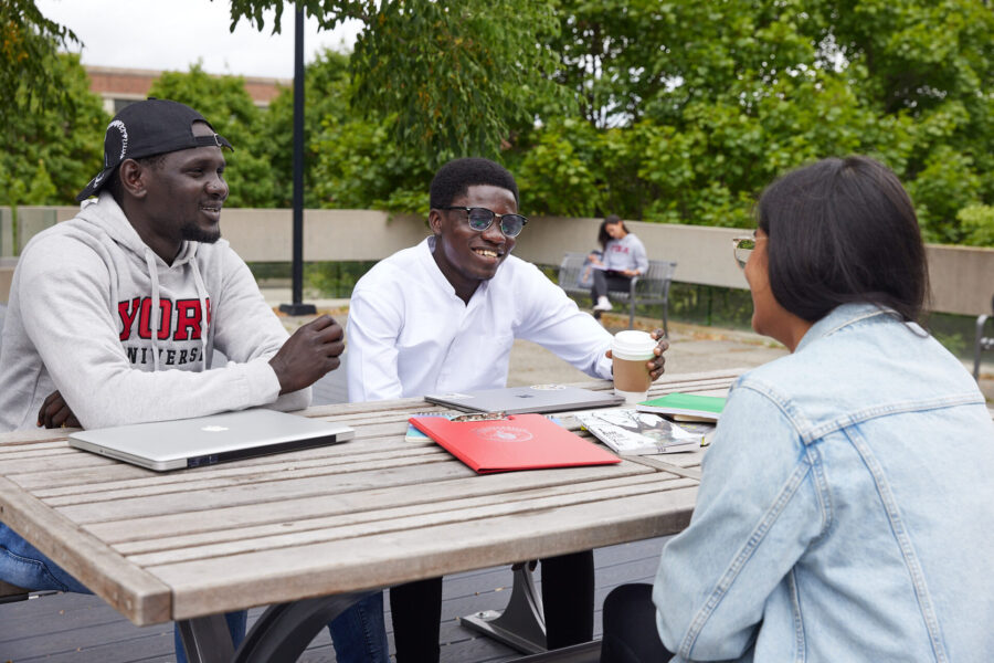 Students sitting at a picnic table