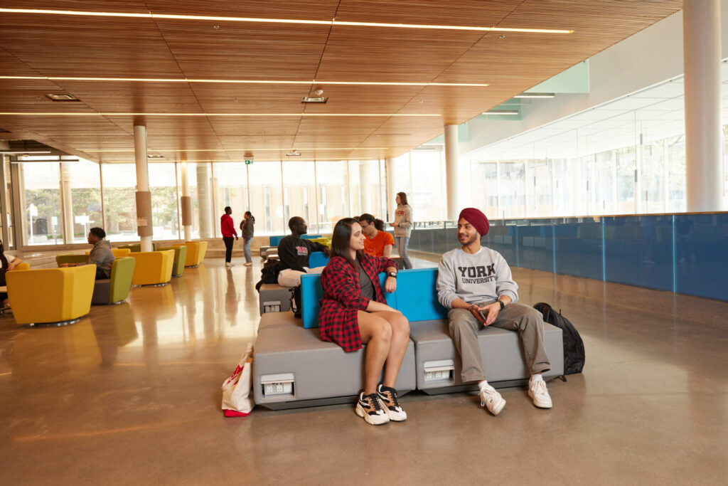 Two students sitting in the lobby