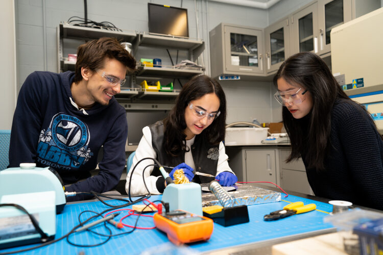 Students with safety goggles working in a lab