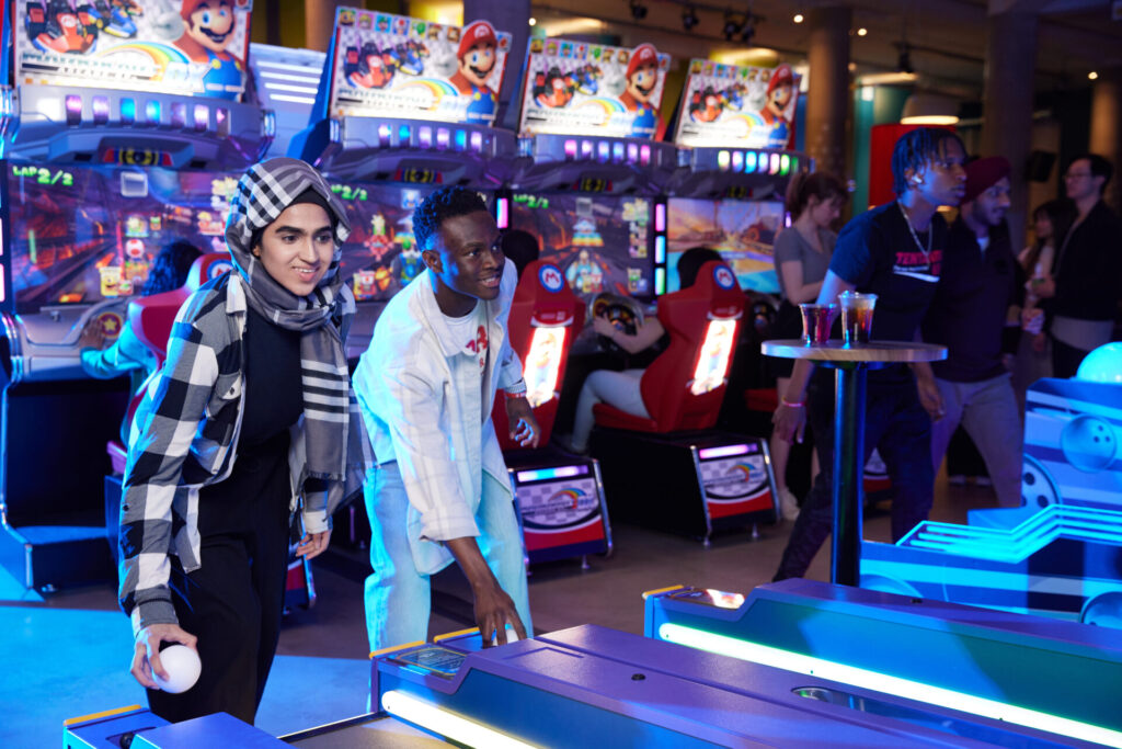 Friends playing bowling in the arcade