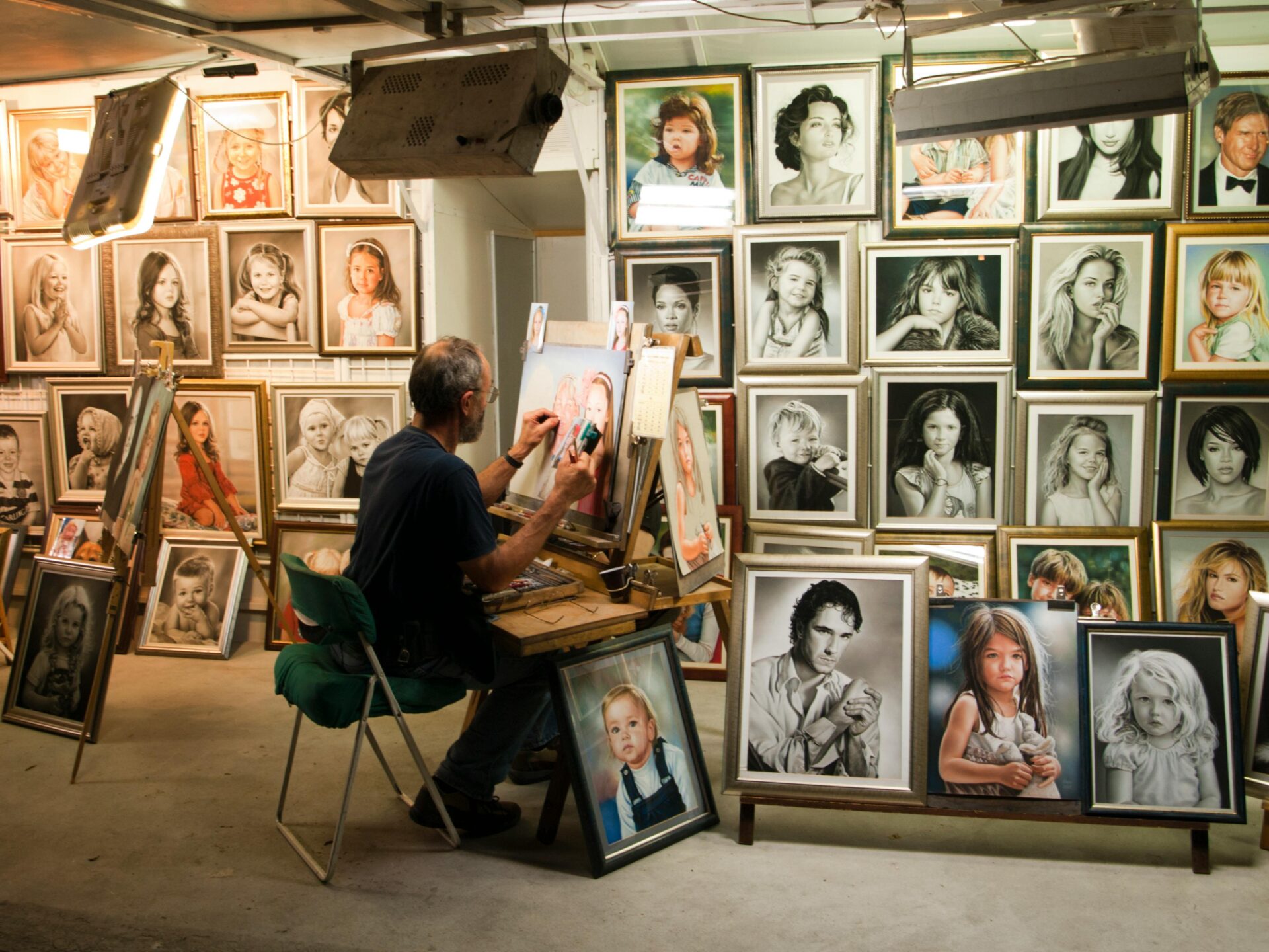 Male sitting on a chair painting insde