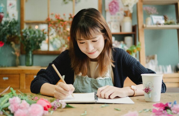 Women writing in book