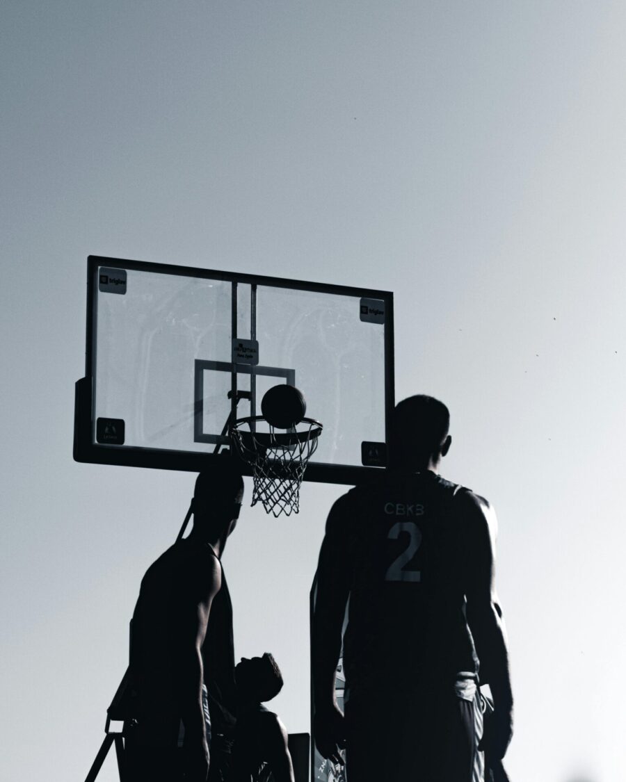 Silhouette of men playing basketball