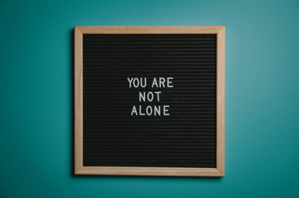 Letter board that says "you are not alone"