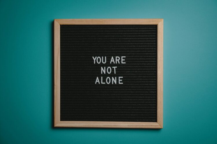 Letter board that says "you are not alone"