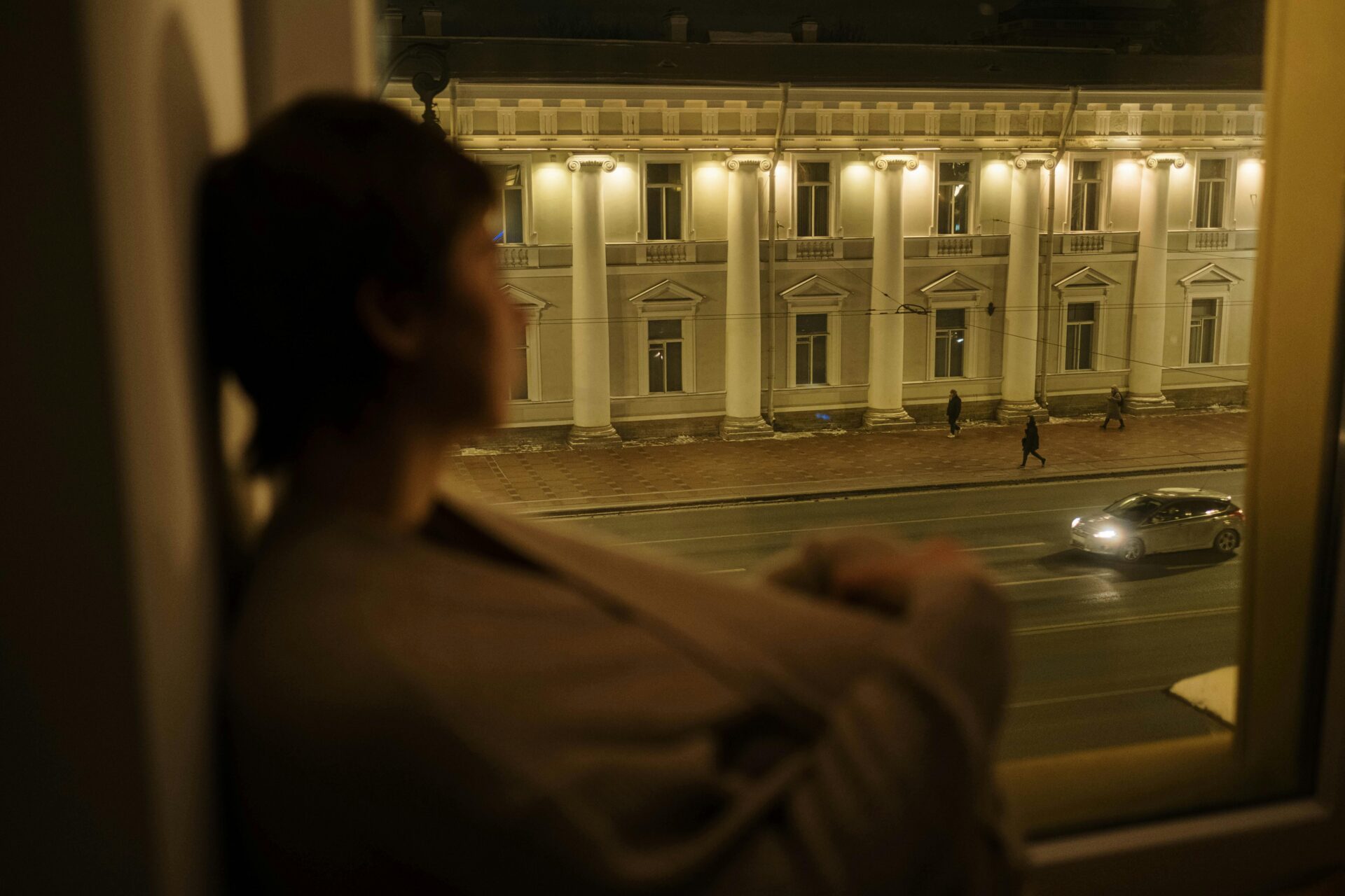 person finding it hard to sleep and sitting by a window