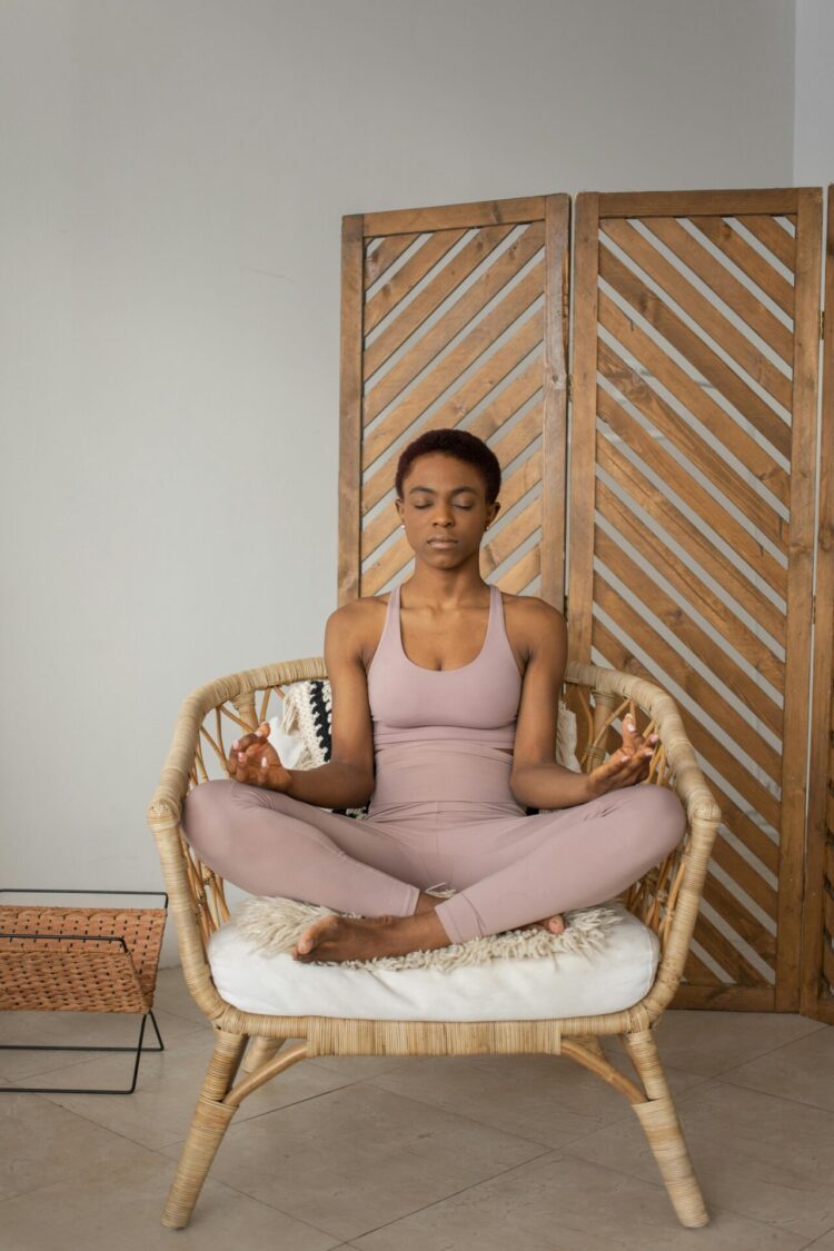 Person sitting on chair doing yoga