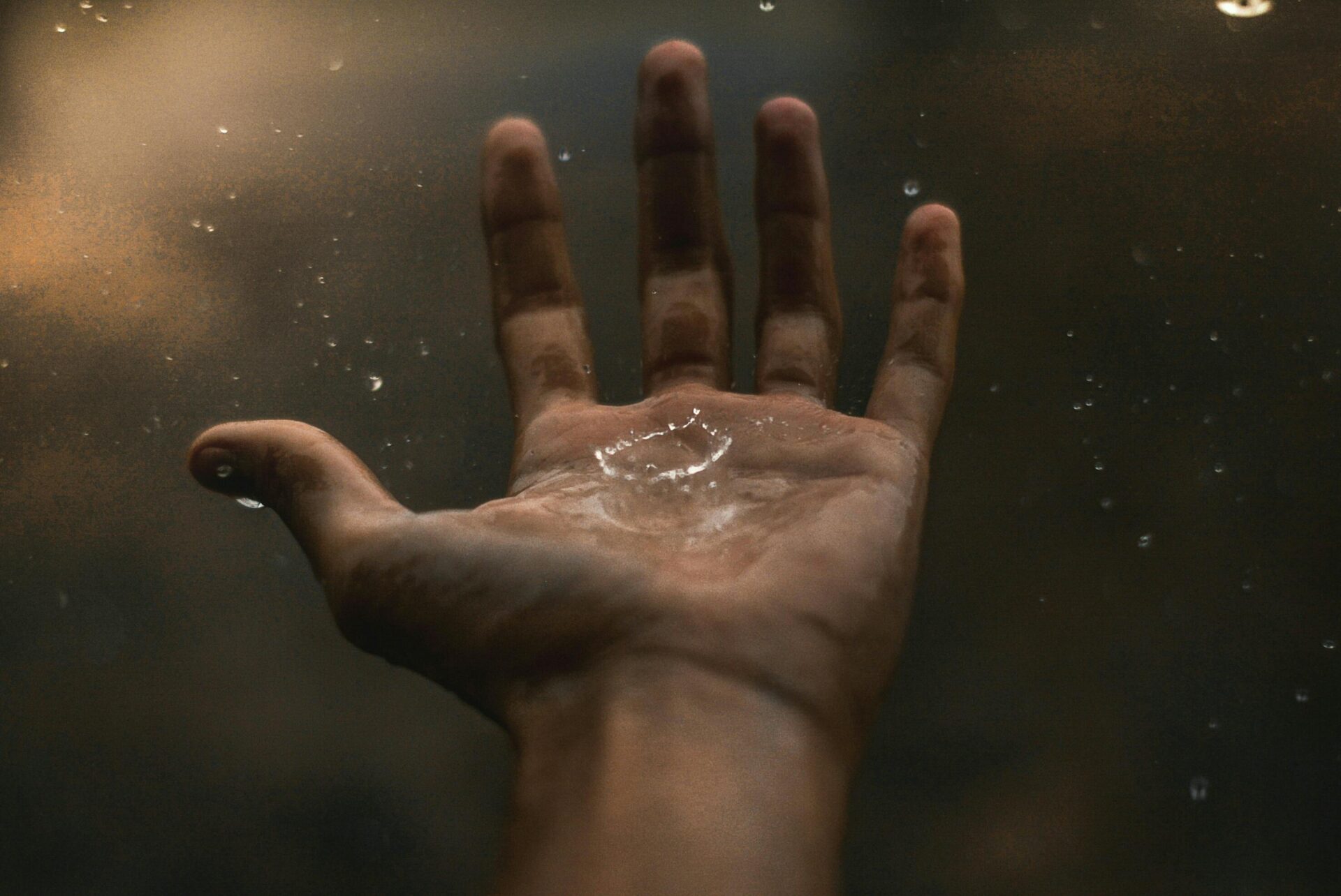 Water droplets falling onto a hand