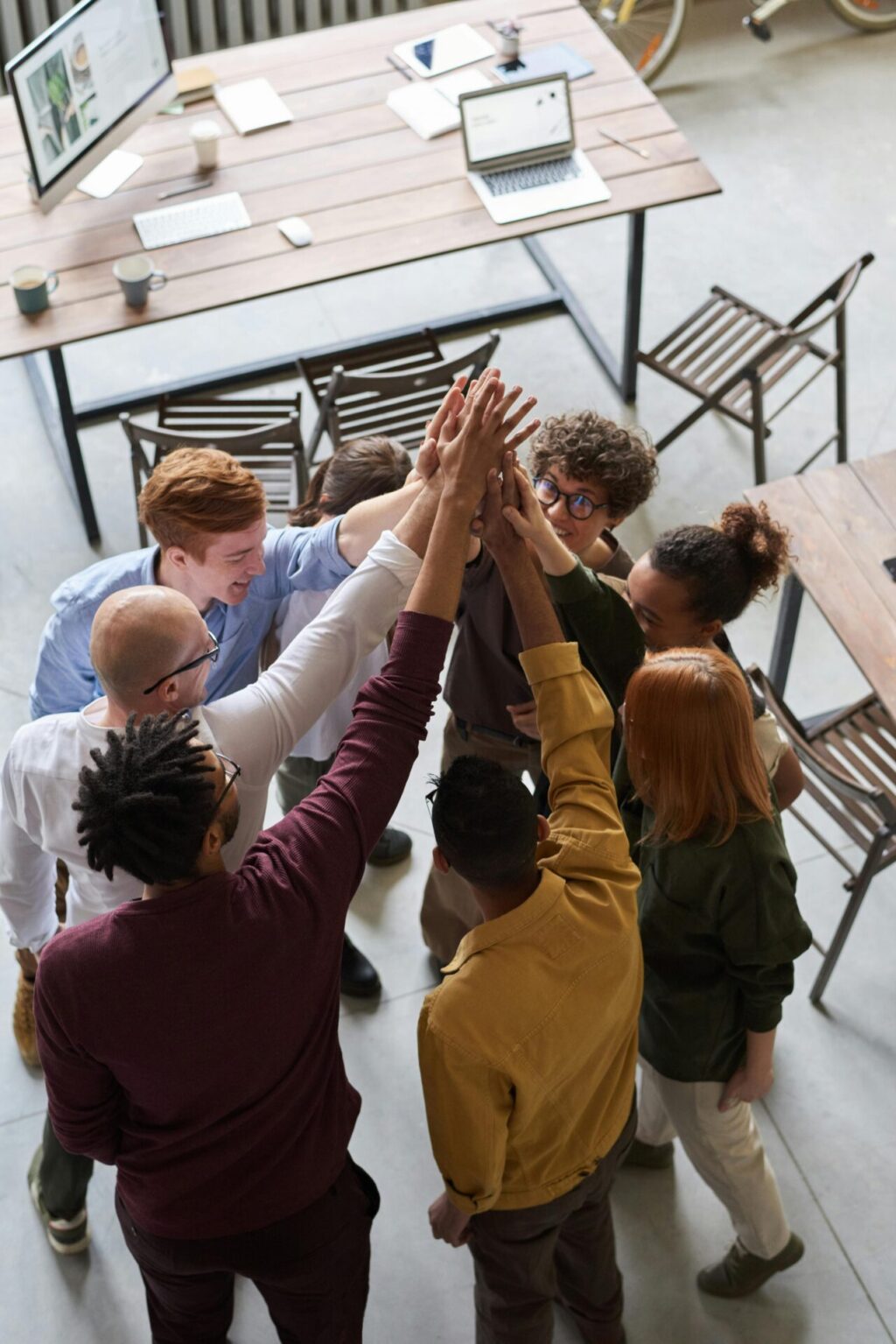 Group of people give a team high five