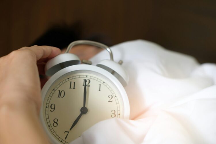 Person holding alarm clock