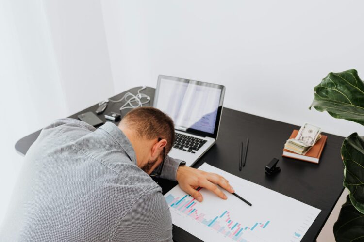 Person sitting at the table putting his head on his arm