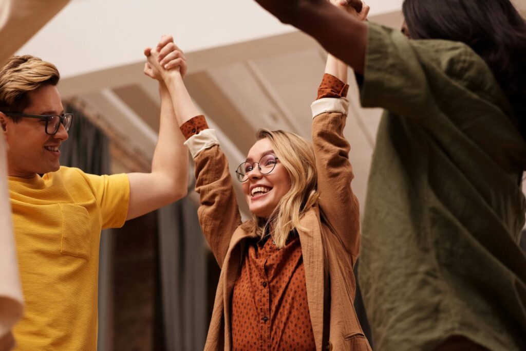 Group of people holding up their hands up