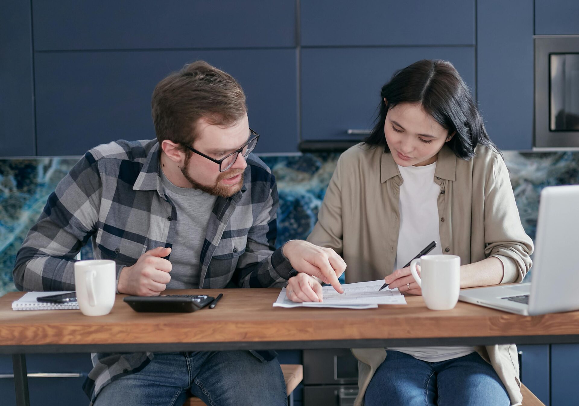 Man and woman sitting at the table looking at documents