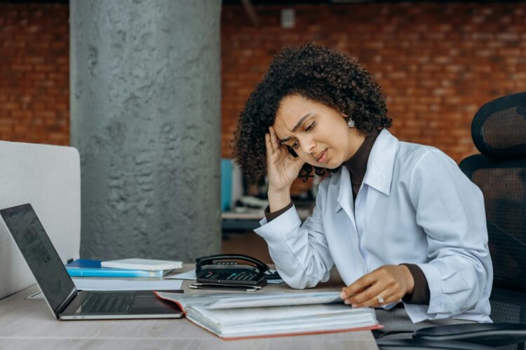 Woman frowning and reading documents