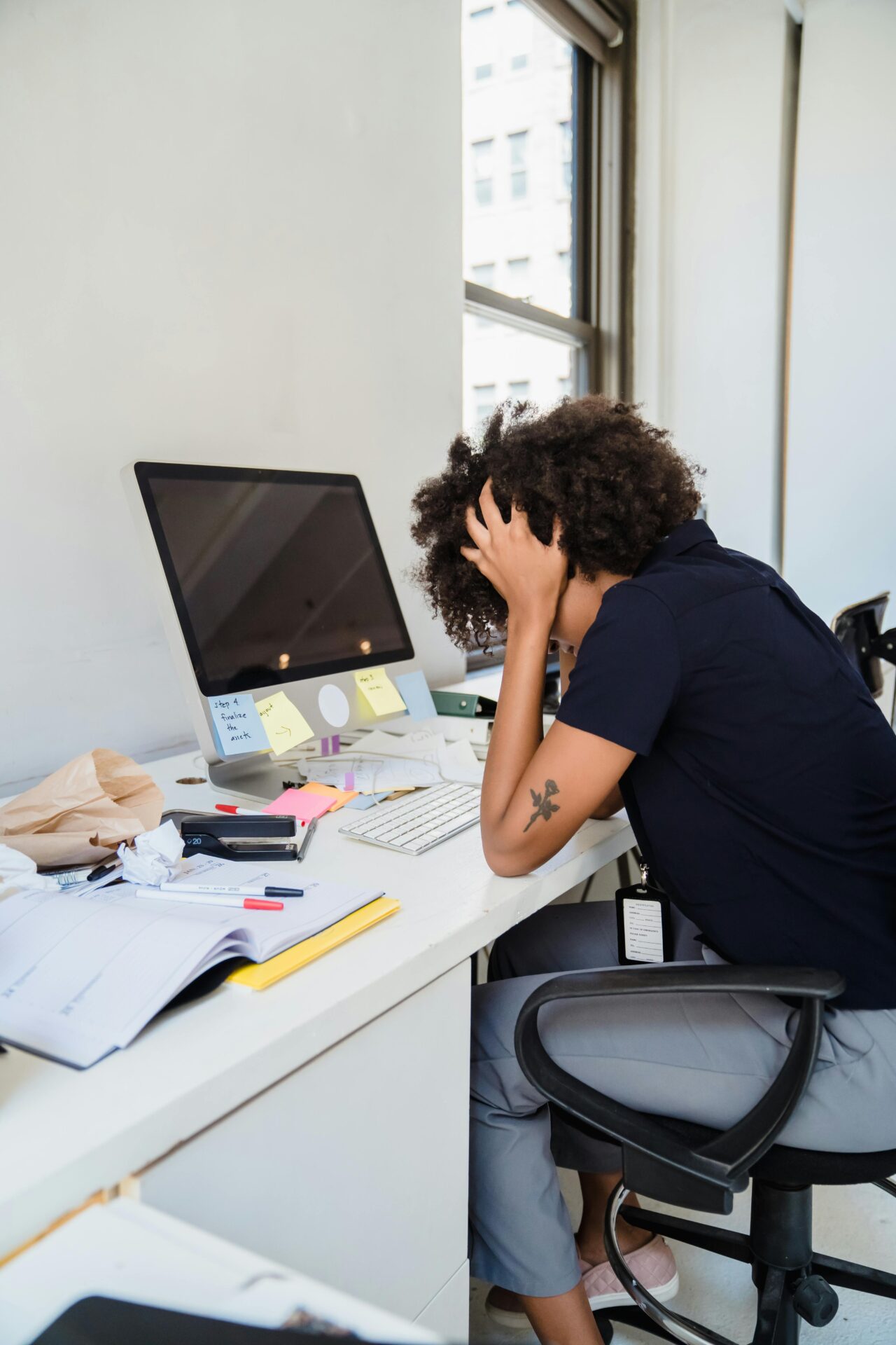 Frustrated woman sitting by desk