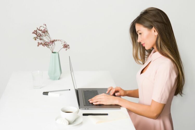 Women in pink dress using computer