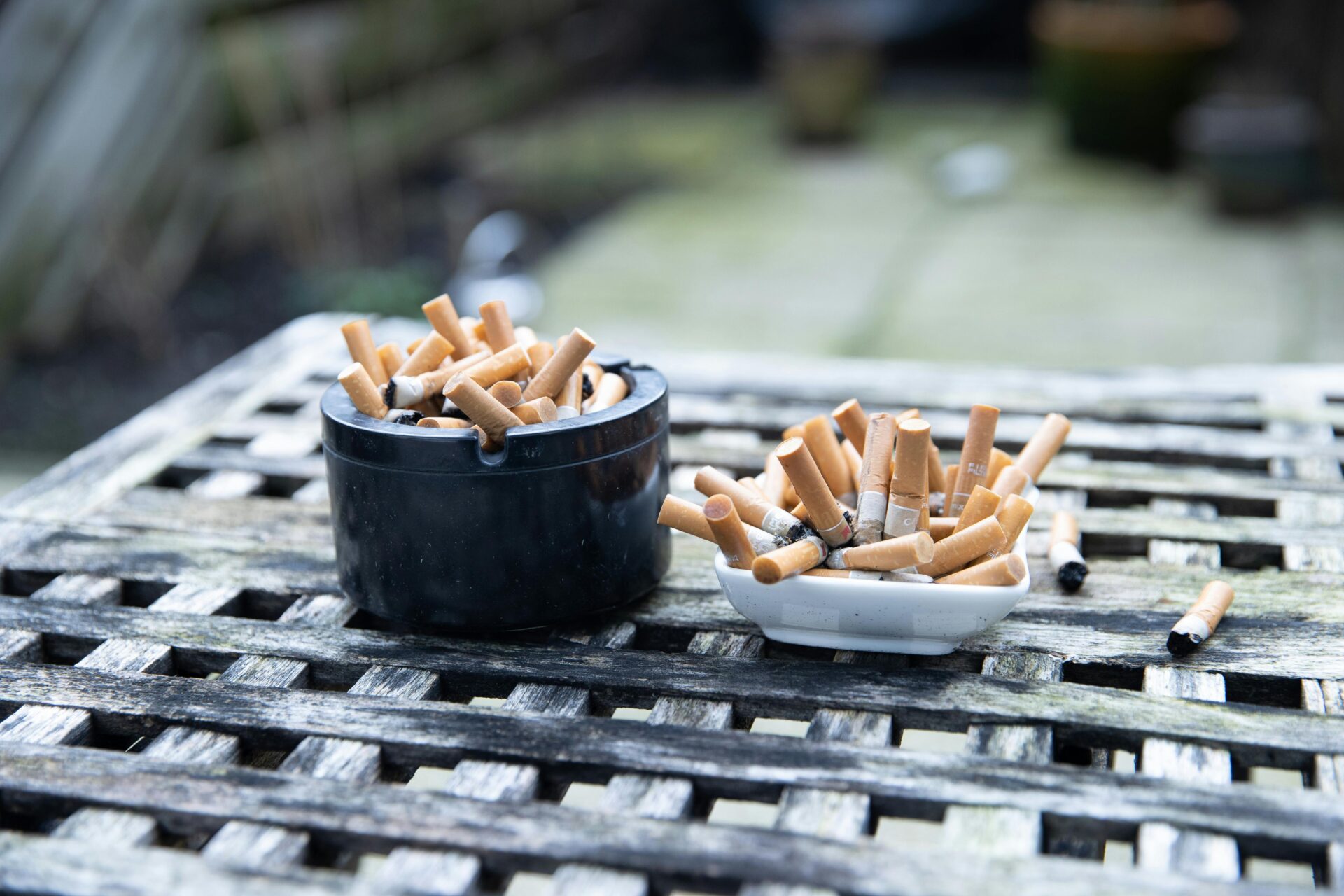 Lots of cigarette butts in two ashtrays