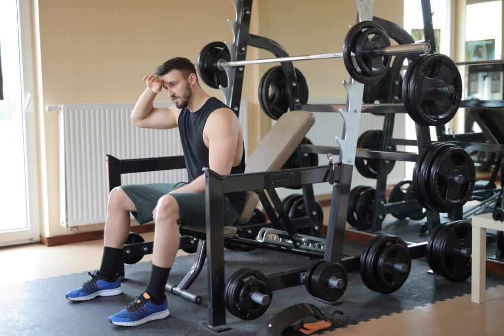 Man sitting on exercise bench