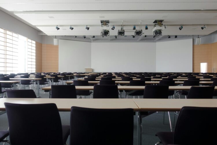 Classroom with white tables and black chairs