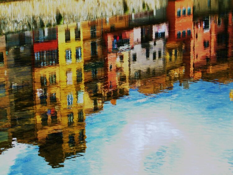 Water reflection of yellow and brown houses