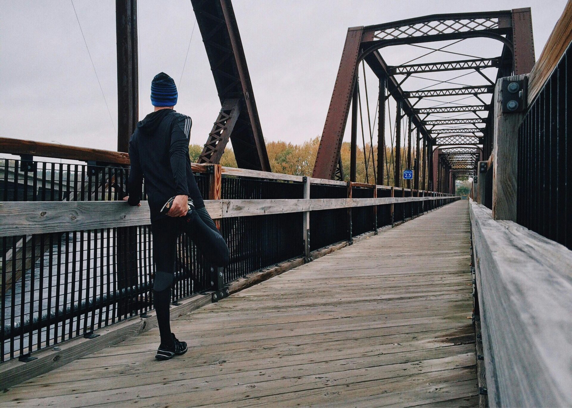 Man standing on bridge