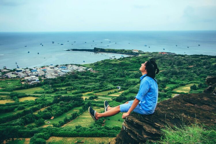 Man sitting on a cliff