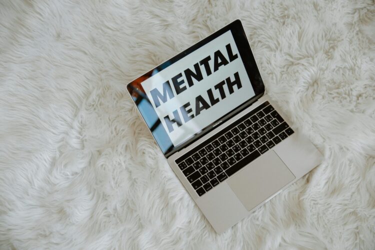 words mental health on laptop screen